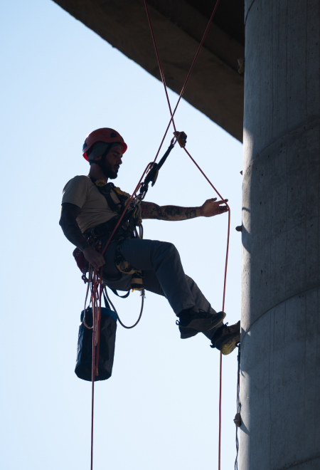Man abseiling wearing a hardhat