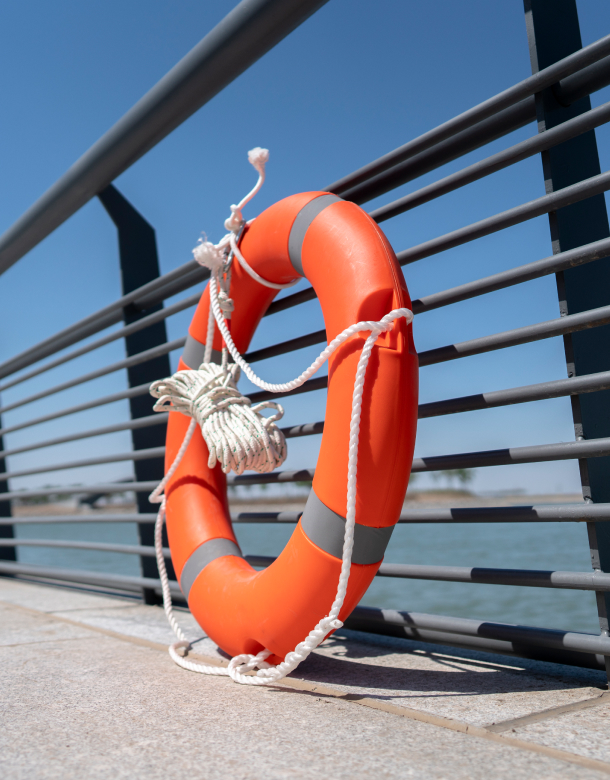 Life buoy standing against a bridge railing