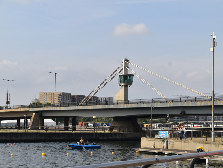 Connaught Road Bridge over Royal Victoria Dock, with a small boat on the water below.
