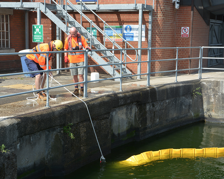 Two team members working on oil spill training.